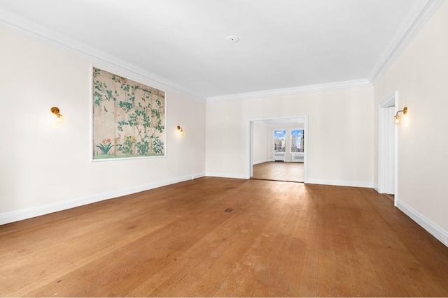 unfurnished living room with ornamental molding and hardwood / wood-style floors