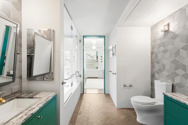 bathroom featuring toilet, parquet flooring, tile walls, and vanity