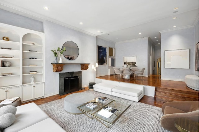 living room featuring wood-type flooring and ornamental molding