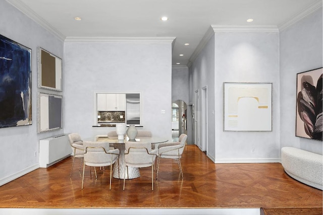 dining area with dark parquet flooring, ornamental molding, and radiator heating unit