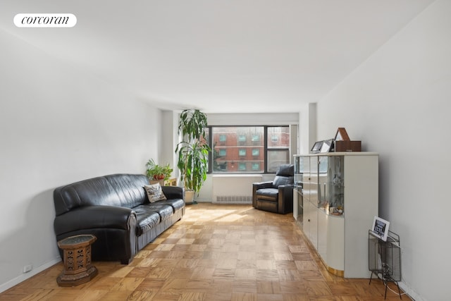 living area with visible vents, radiator, and baseboards