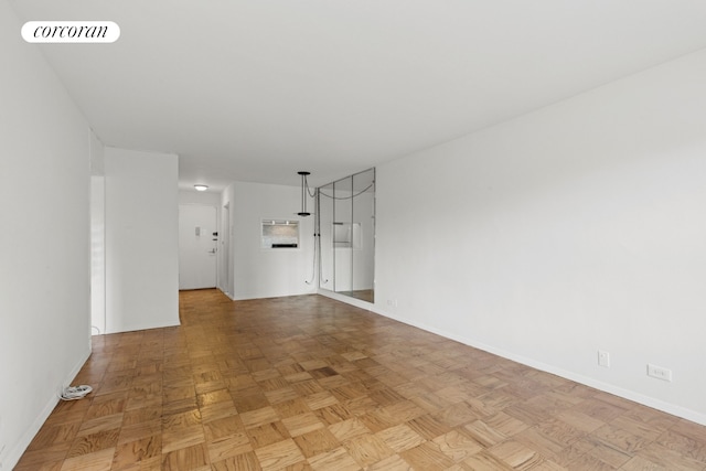 unfurnished living room featuring visible vents and baseboards