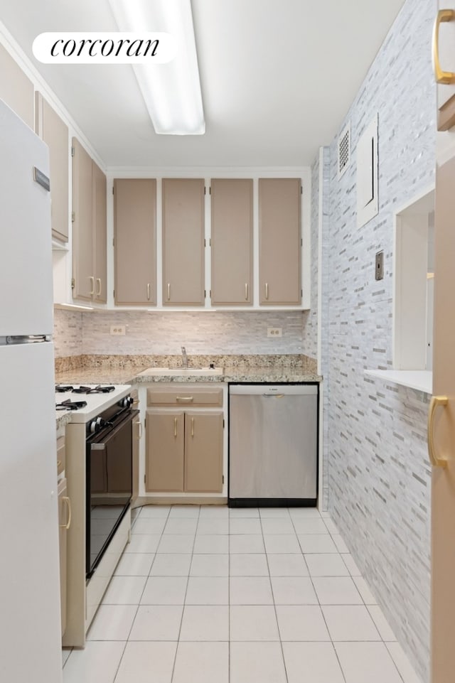 kitchen featuring decorative backsplash, visible vents, light tile patterned floors, white appliances, and cream cabinetry
