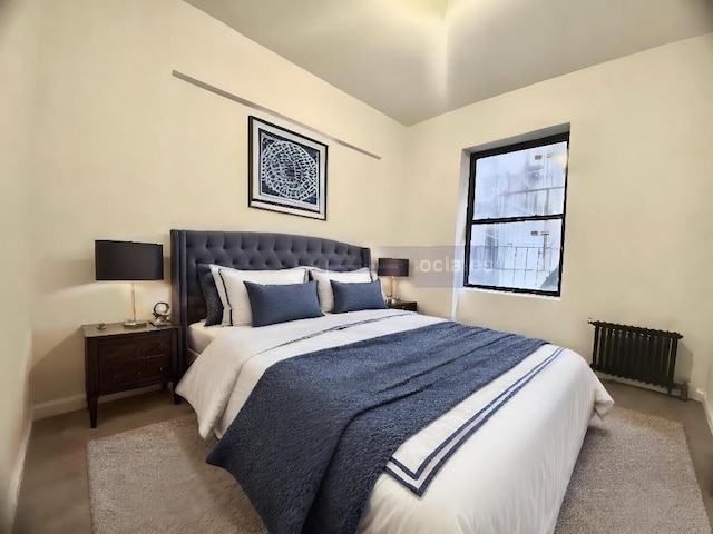 bedroom with radiator and light colored carpet