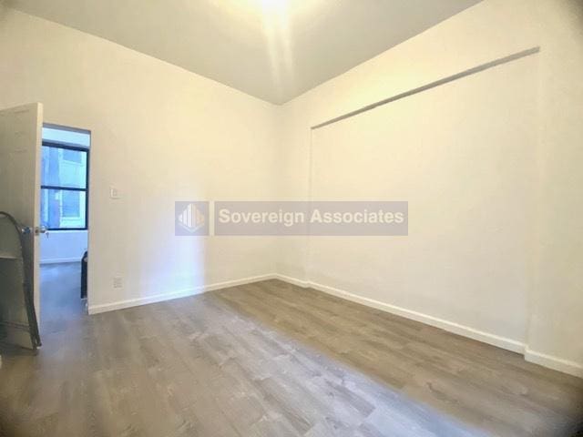 spare room with dark hardwood / wood-style flooring