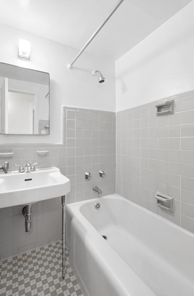 bathroom with tile walls and a sink