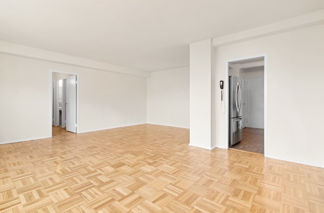 unfurnished room featuring light parquet floors