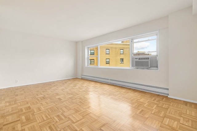 spare room featuring a baseboard radiator, baseboards, and cooling unit