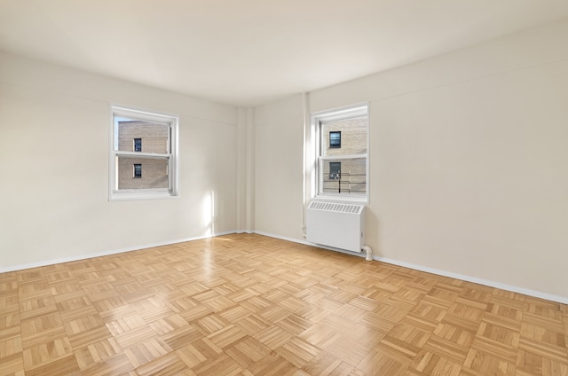 spare room with radiator and baseboards