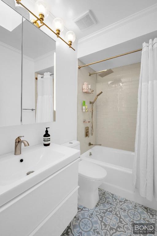 bathroom featuring tile patterned flooring, crown molding, shower / bath combination with curtain, and toilet