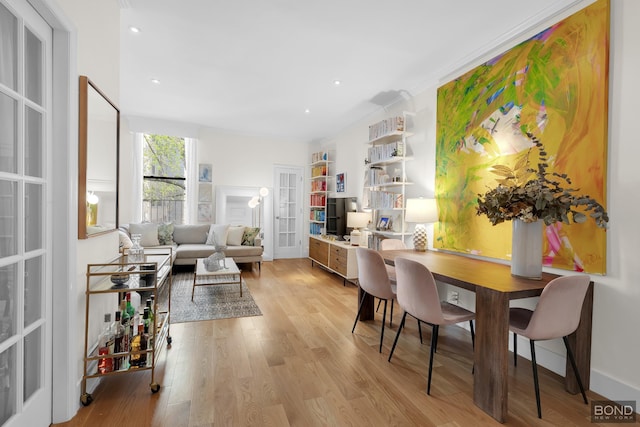 dining room featuring light wood-style floors, recessed lighting, and french doors