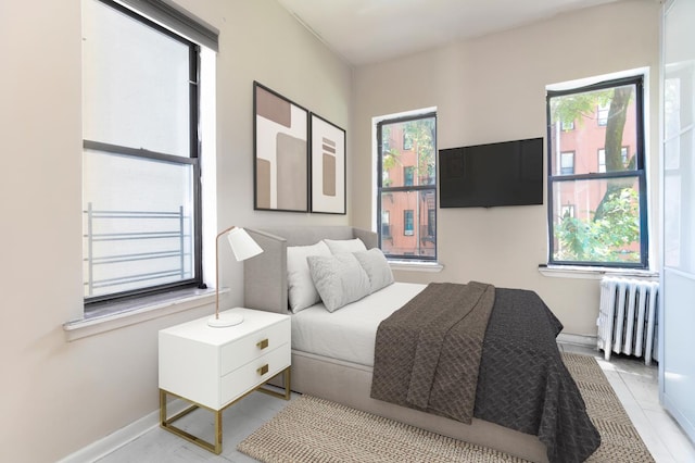 bedroom featuring radiator and baseboards