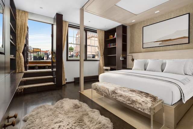 bedroom featuring wood finished floors and baseboards