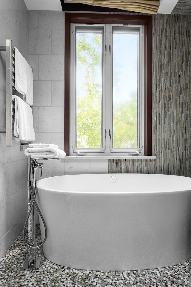 full bath featuring a soaking tub