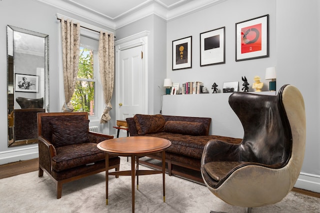 living area with wood finished floors and crown molding