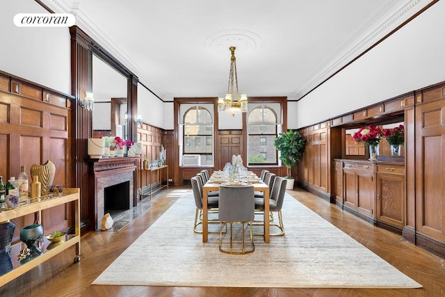 dining area with ornamental molding and a chandelier