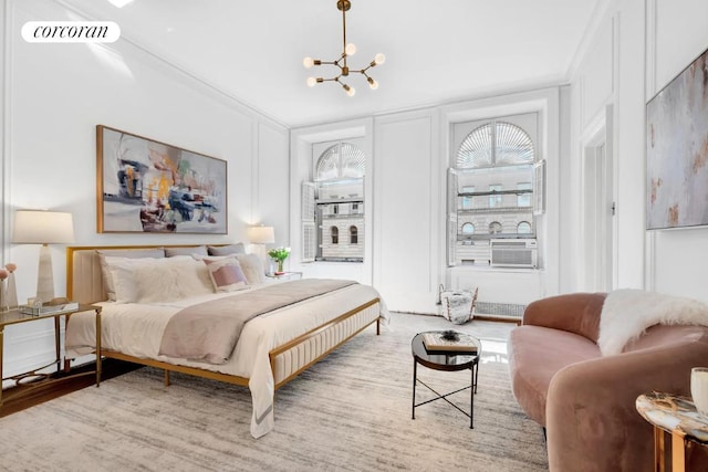 bedroom with crown molding and a chandelier