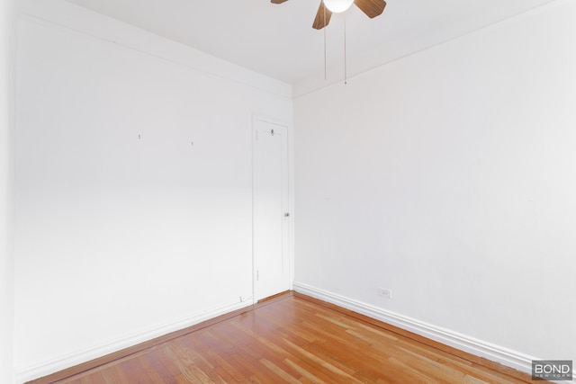 empty room with light wood-type flooring, baseboards, and a ceiling fan