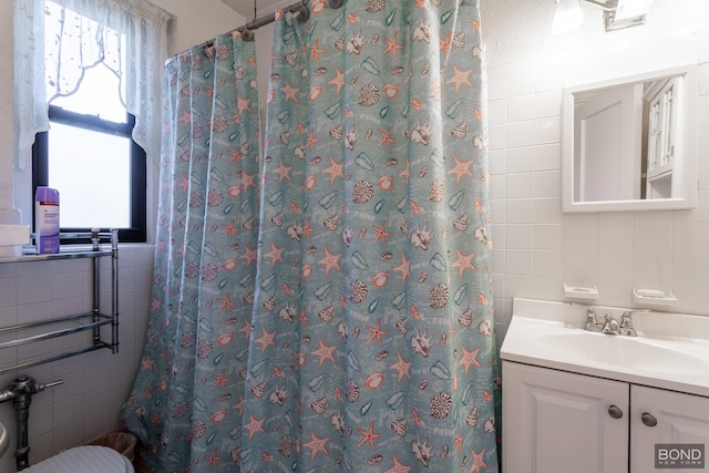 full bathroom with curtained shower, tasteful backsplash, tile walls, and vanity