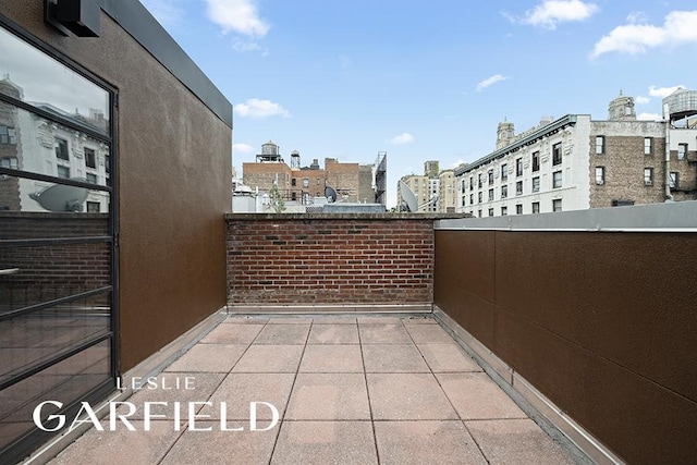 view of patio featuring a view of city and a balcony