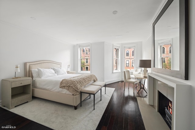 69 W 83rd St, New York City, NY 10024 - bedroom with ornamental molding, multiple windows, hardwood / wood-style flooring, and a premium fireplace