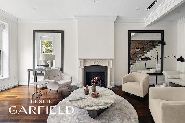 living area with dark wood-type flooring and ornamental molding