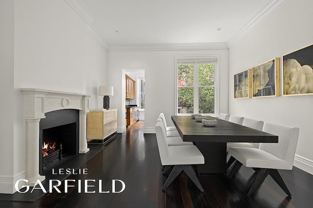 dining area with baseboards, crown molding, a lit fireplace, and dark wood-style flooring