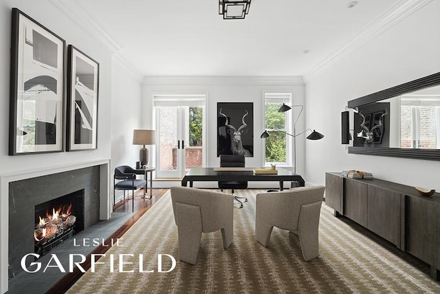 dining area with wood finished floors, a fireplace, and ornamental molding