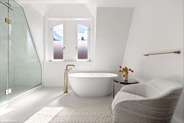 69 W 83rd St, New York City, NY 10024 - bathroom featuring a stall shower, a soaking tub, baseboards, and tile patterned floors