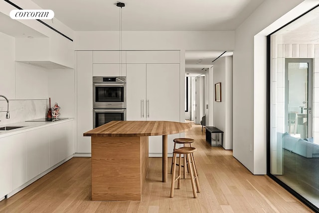9 Chapel St Phb, Phb, New York City, NY 11201 - kitchen with modern cabinets, wood counters, white cabinets, stainless steel double oven, and light wood-style floors