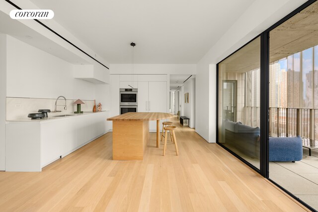 sitting room featuring light wood-style flooring