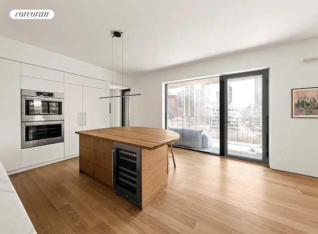 9 Chapel St Phb, Phb, New York City, NY 11201 - kitchen featuring beverage cooler, modern cabinets, double oven, wooden counters, and light wood-style flooring