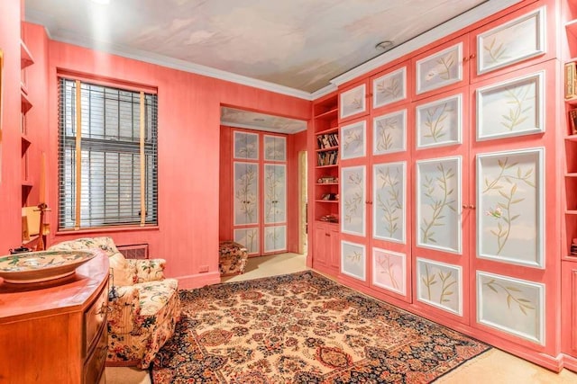 sitting room featuring crown molding and built in features