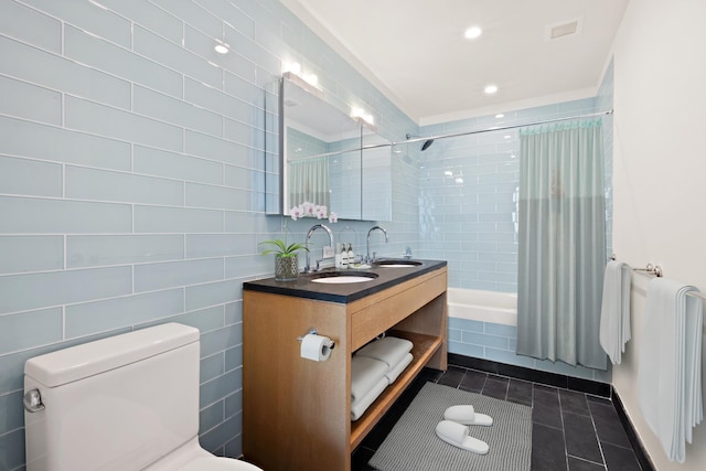 full bathroom with toilet, a sink, visible vents, tile patterned floors, and shower / bath combo with shower curtain