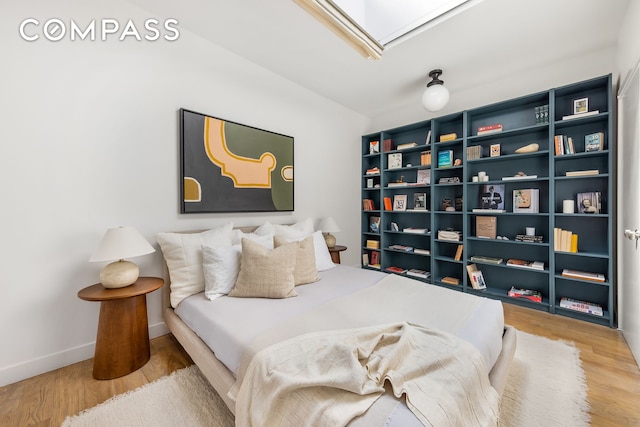 bedroom featuring baseboards and wood finished floors