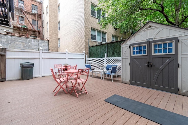 wooden terrace featuring a shed