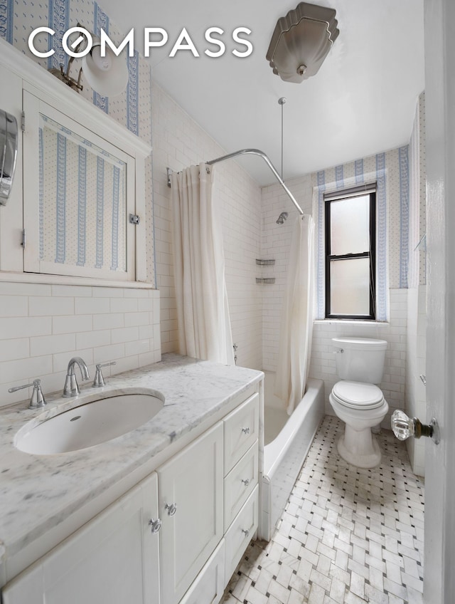 full bath featuring shower / bath combo, tile walls, toilet, and vanity