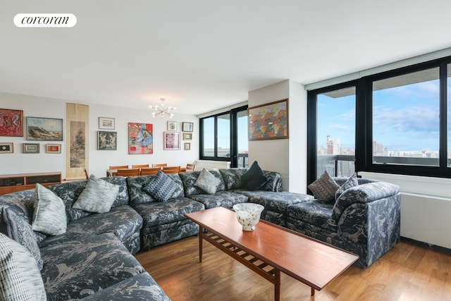 living area featuring visible vents, a view of city, a notable chandelier, and wood finished floors