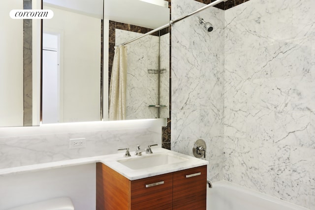 bathroom with vanity, backsplash, and shower / tub combo