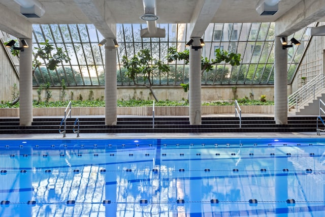 view of swimming pool featuring a lanai