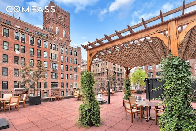 view of patio / terrace with a pergola and outdoor dining area