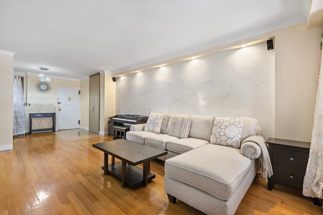 living room featuring crown molding, light hardwood / wood-style floors, and a tile fireplace