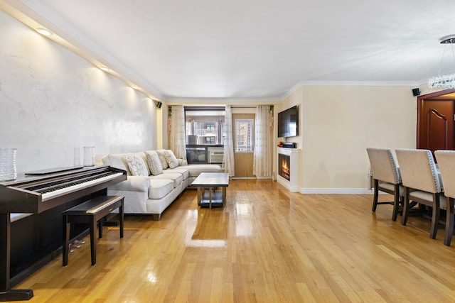 living room featuring crown molding and light hardwood / wood-style floors