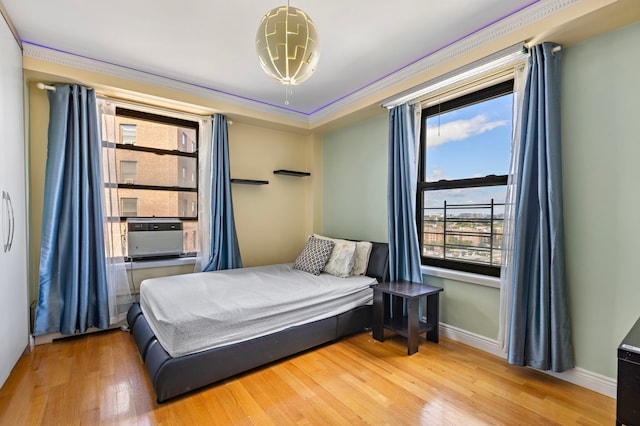 61-35 98th St Unit 15-E, New York City, NY 11374 - bedroom with wood finished floors, cooling unit, and ornamental molding