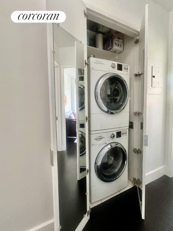 laundry area featuring stacked washing maching and dryer