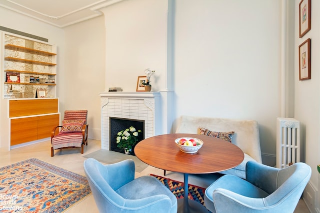 dining room with radiator and a fireplace