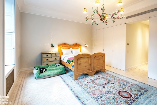 bedroom with baseboards, a closet, and crown molding