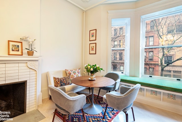 dining space with a tiled fireplace