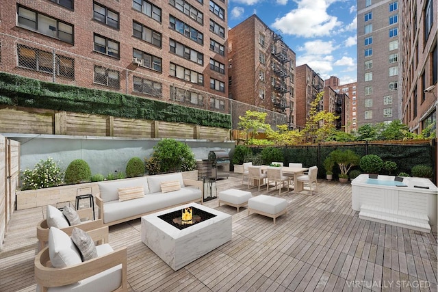 view of patio with area for grilling and an outdoor living space with a fire pit