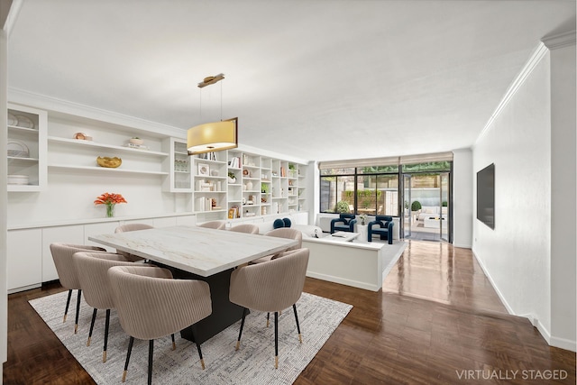 dining room with baseboards and crown molding